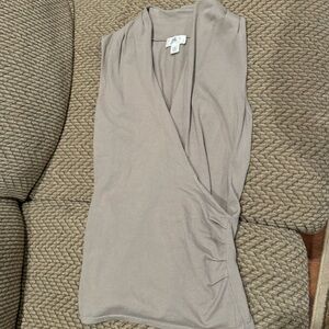 Women’s sleeveless soft grey top with side ruching and deep V neckline.